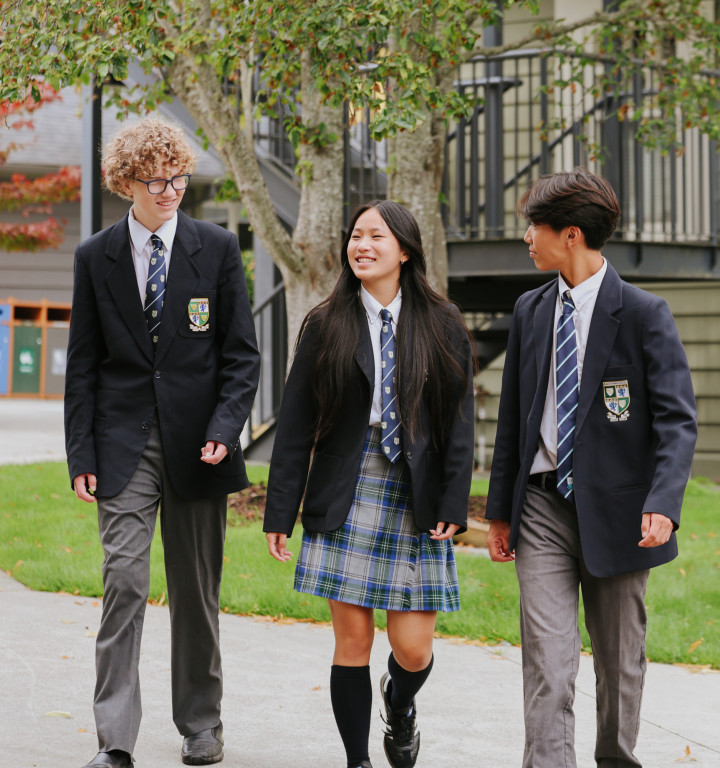 Schüler in Uniform gehen über den Campus