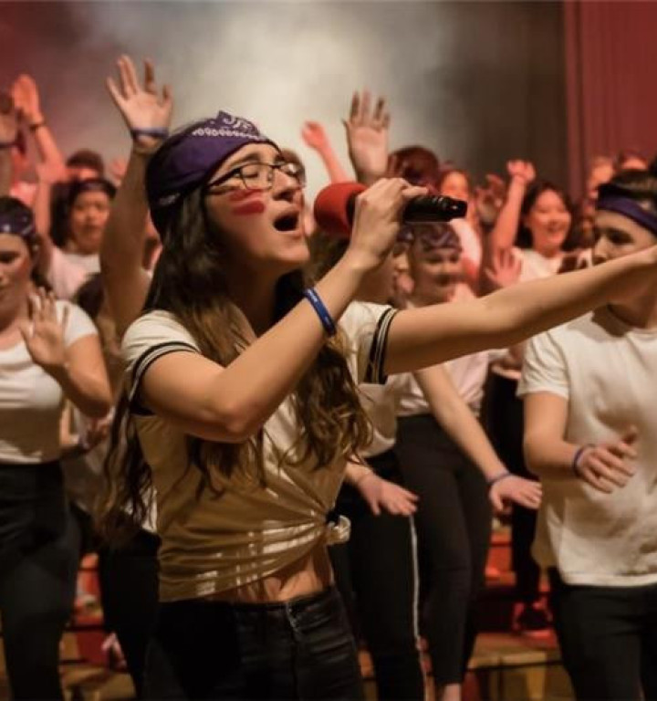 Schülerinnen und Schüler tanzen und singen,